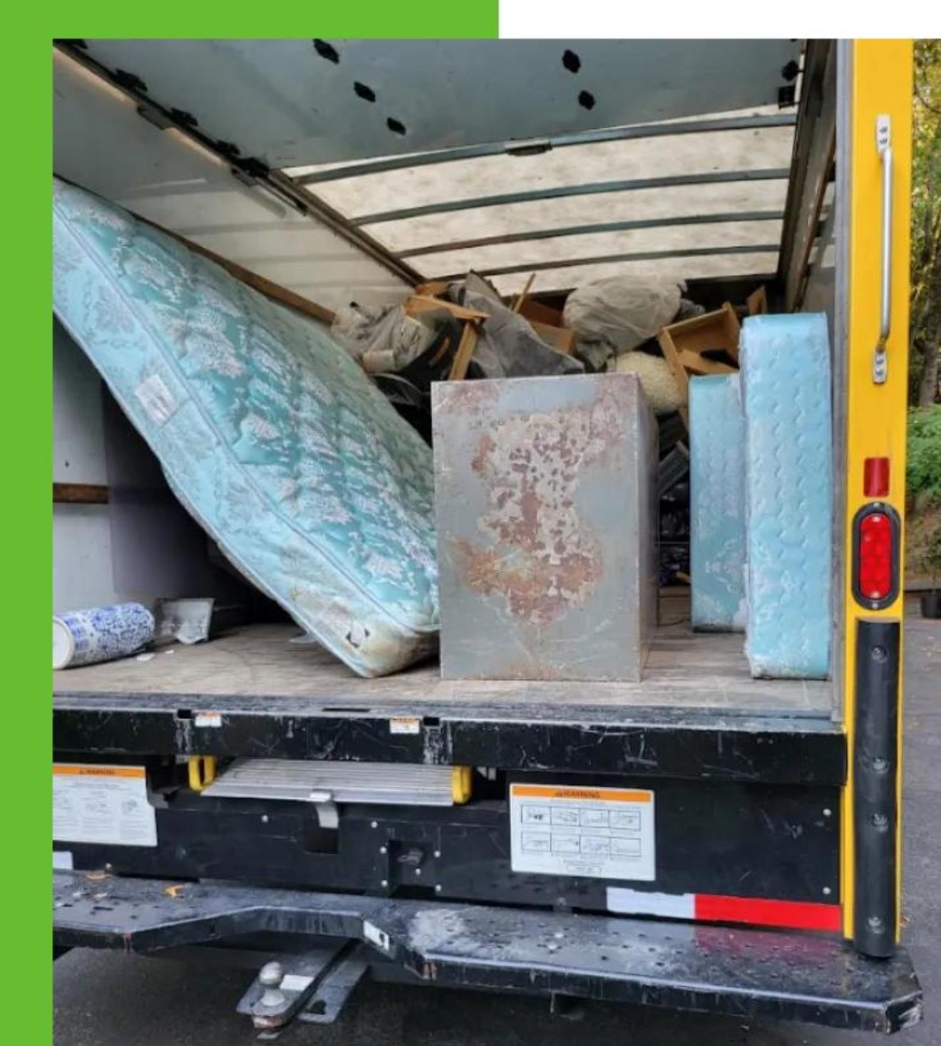 Truck loaded with mattresses and household debris